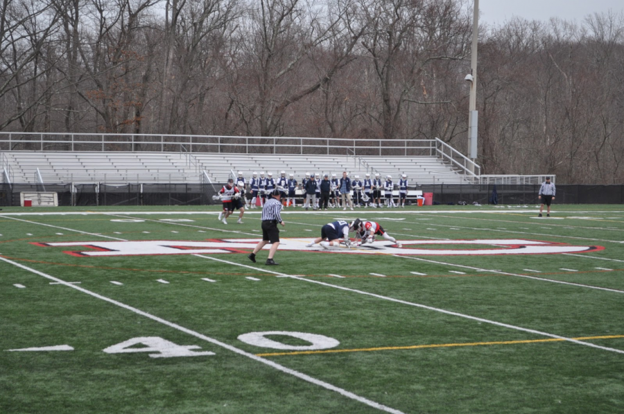 Staples fights for possession against New Canaan to begin the game