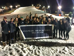 After placing second in the state tournament, the Staples girls’ ski team poses at the bottom of Mount Southington following the awards ceremony.