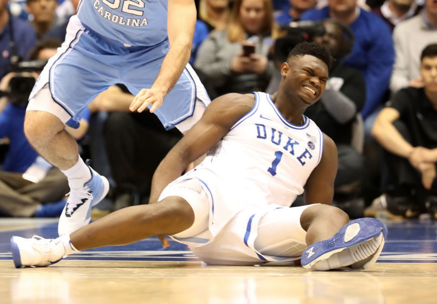 Luke Maye (32) gets the ball as Zion Williamson (1) falls after his foot cuts the bottom of his Nike shoe. 
