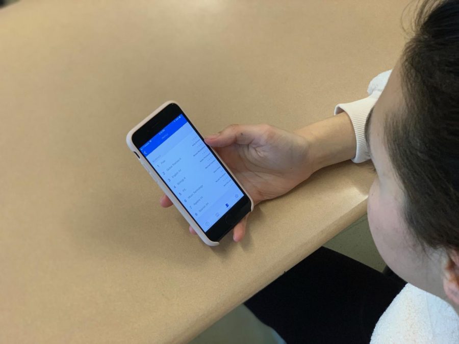 A Staples sophomore checks the schedule of a peer during class. iStaples is not beneficial in the long term because its an invasion of privacy and it prompts unnecessary comparisons between members of the student body.