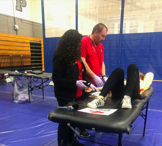 Phlebotomists+from+the+Red+Cross+take+blood+from+one+of+the+29+Staples+student+volunteers.