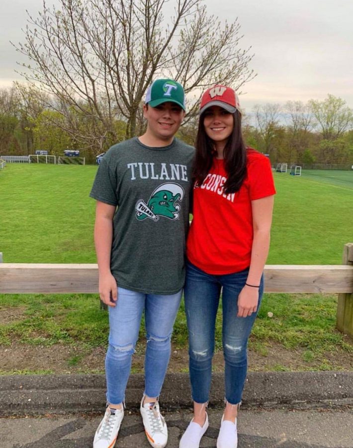 Hannah Bolandian 19 and Nicky Brown 19 pose for a picture before school on decision day. Both are decked out in the college they are attending. 