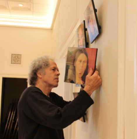 Miggs Burroughs hangs his lenticular art the day before the show.