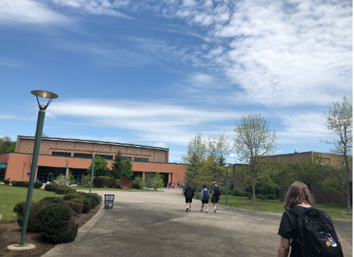 Students from the period five Latin class venture down to the courtyard to complete their assignment on a sunny day.
