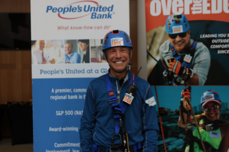 Ed Finnigan prepares to remove his harness after rappelling the People’s United Bank in Bridgeport, Connecticut.