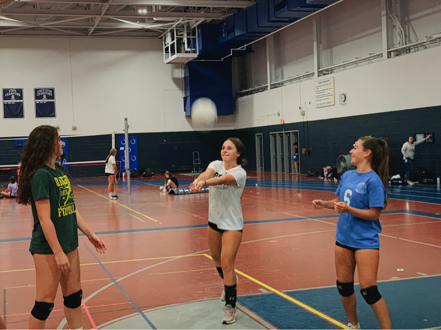 Staples+sophomores+%28from+left%29+Layla+Bloomingdale%2C+Karina+Murray+and+Chloe+Murray+warm-up+for+their+volleyball+practice+that+is+over+two+hours+every+day.+After+their+workout%2C+they+must+go+home+to+do+hours+of+homework.%0A