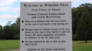 An Informational sign stationed at the entrance of Winslow Park explains the rules and policies for leash restrictions. Local dog walkers reported spotting many dogs walking off leash in the park.