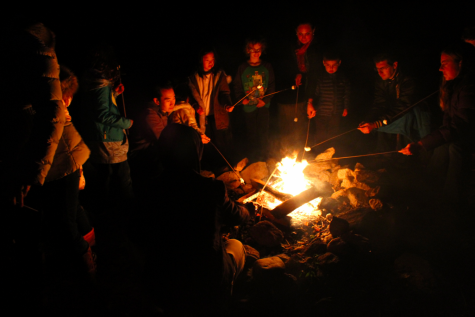 Friends and families gather around the Earthplace campfire, making s’mores and listening to spooky campfire stories.