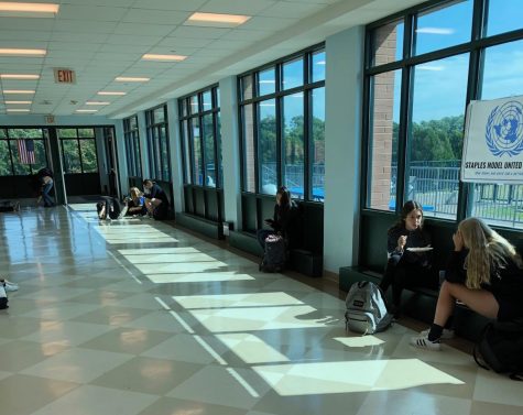 Staples students enjoy eating their lunch in the hallway surrounding the cafeteria.