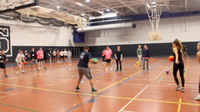 A+police+officer+participating+on+a+student+team+goes+to+throw+the+dodge+ball+after+the+game+started.+