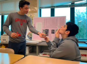 As Valentines Day approaches, Jackson Hochhauser ’22 shows his appreciation for his friend by gifting him candy.