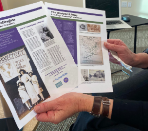 Kathie Bennewitz, a curator for the WestportREADS exhibition “Westport’s Suffragists - Our Neighbors, Our Crusaders, displays an infographic by the Westport library about the upcoming exhibit.  