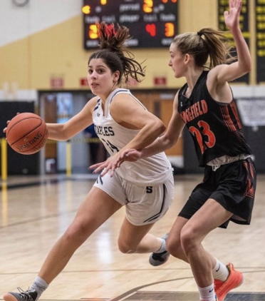 Arianna Gerig ’21 with the ball going in for a layup at Trumbull High School for the FCIAC championship game against the Ridgefield Tigers.
