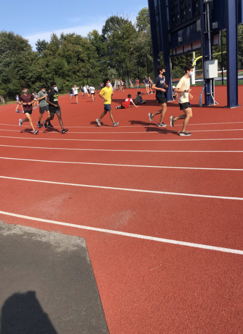 Staples cross country runners wear masks and socially distance while running in their small cohorts at practice.
