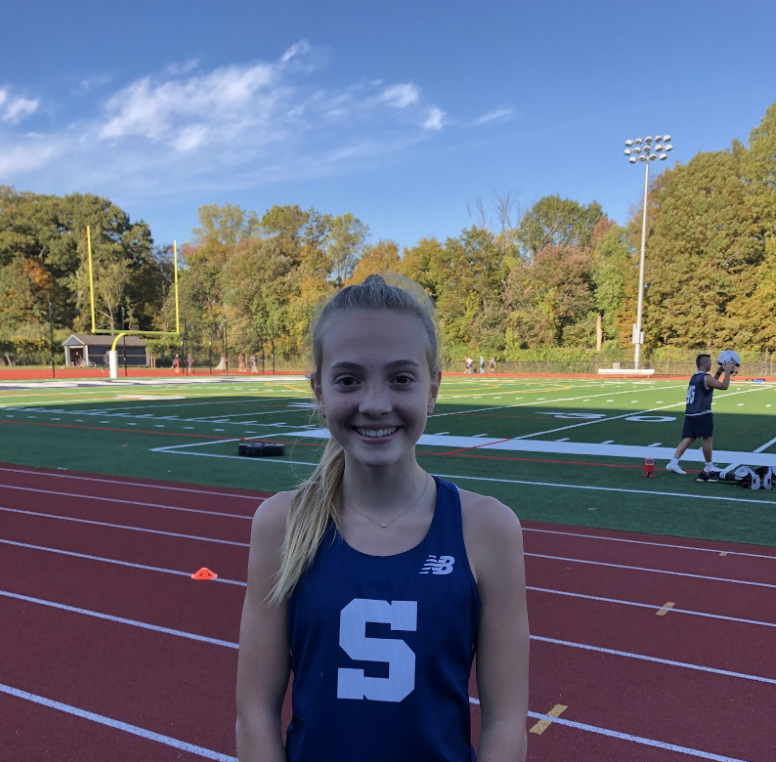 Emma+Morris+%E2%80%9924+warms+up+for+her+meet+on+Oct.+14%2C+as+she+prepares+to+run+as+the+only+freshman+on+the+varsity+girls%E2%80%99+cross+country+team.%0A