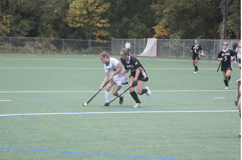 Senior captain Laine Ambrose ’21 (left) chases down a ball in a game against Ridgefield. The Boston College commit has been a part of all three of the state champion teams since she arrived at Staples. 

