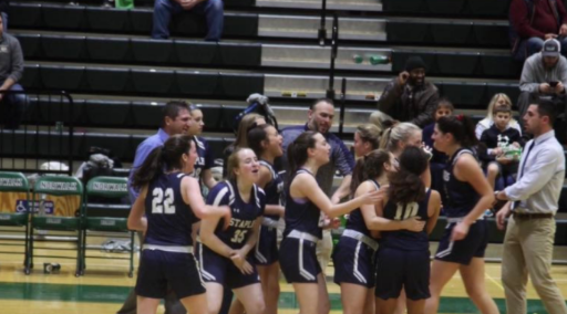 The Staples girls basketball team celebrating after upsetting Norwalk on the road. 