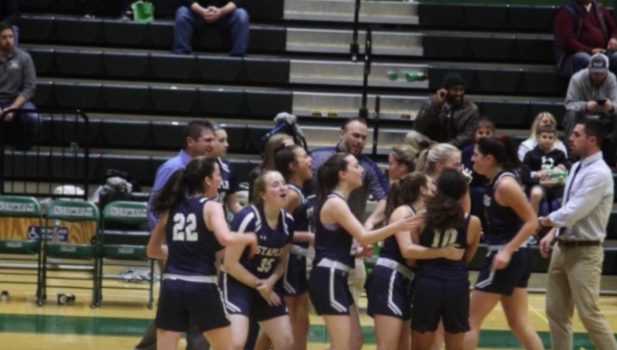 Staples girls basketball celebrates after upsetting Norwalk on the road.