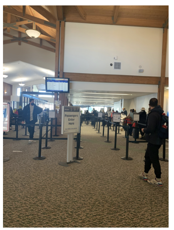 Travelers in EGE airport in Colorado stay six feet apart from others while waiting in security lines. 