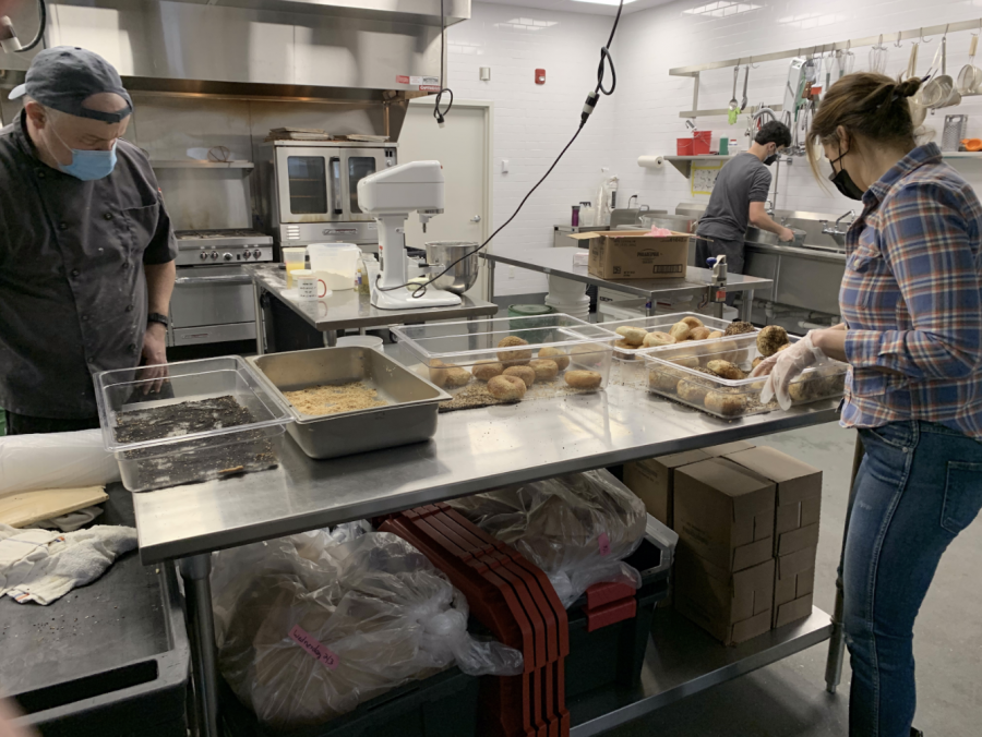 The staff of Westport-based Pop Up Bagels works to prepare bagels for pick-up in the Manna Toast “Hub kitchen.”