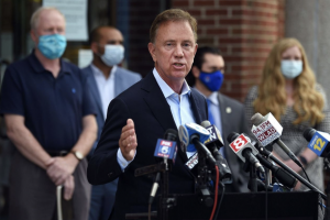 Governor Ned Lamont speaks at a press conference regarding COVID-19. The updated approach announced Monday will be age-based and allow exceptions for educators and childcare providers.  