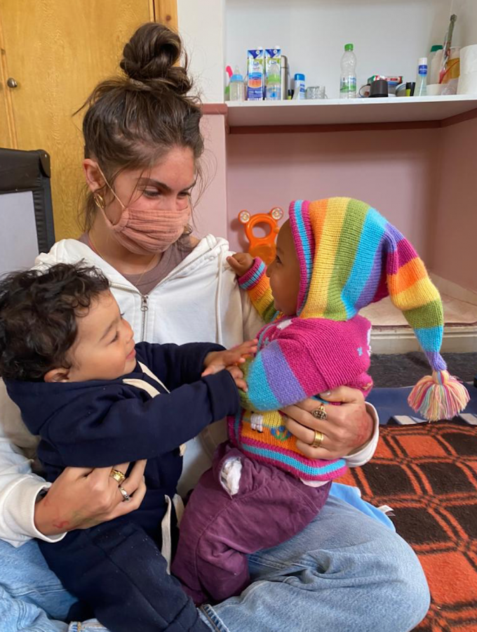 Remi Levitt 21 sits with two children from the orphanage where she volunteers. The American Friends of Atlas Kinder Foundation is an organization founded by her mother, Keri Levitt, and has inspired Remis return to Marrakech this winter. 