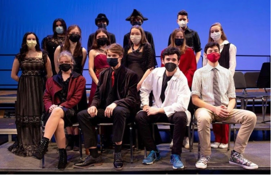 Players%E2%80%99+Dracula+cast+don+red+and+black+costumes+for+the+show+as+well+as+coordinating+masks.