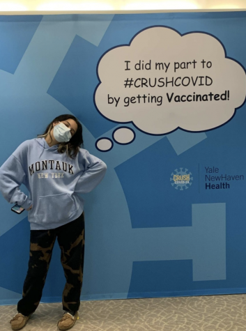 Sophie Spheeris ’23 stands in front of a sign after receiving her second dose of the COVID-19 vaccination, only a couple of weeks after it opened up for 16 years and older. 