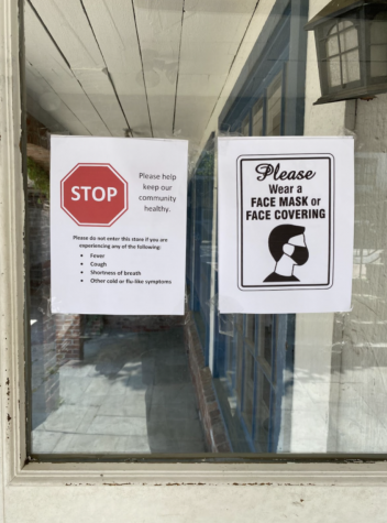 Signs posted in the windows of Brandy Melville in downtown Westport show customers that masks are still required despite the recent CDC guidelines.