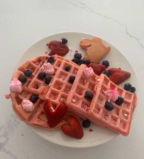 I used pink whipping cream, blueberries, strawberries and heart shaped sprinkles to make the perfect Valentine's Day treat.