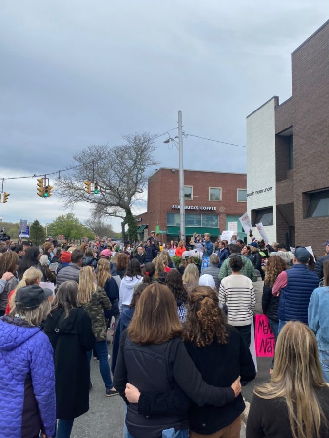 Pro-abortion rights protestors gather in downtown Westport holding signs supporting DefenDemocracy’s cause and listening to speakers.