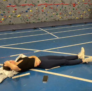 Kristen Devine ’25 needs to lay down in Sophomore Lifetime Activities due to overheating. Devine is already hot from climbing on the rock wall during class. 