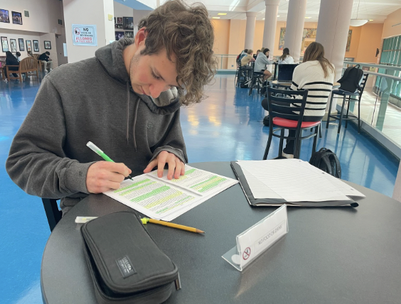 Jack Marshall ’24 diligently works on his assignments outside of the school’s auditorium. 