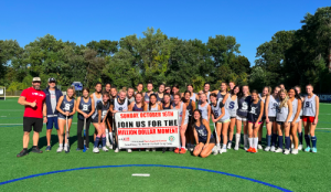  The Staples field hockey program poses with “Push Against Cancer” fundraiser founder Andrew Berman.