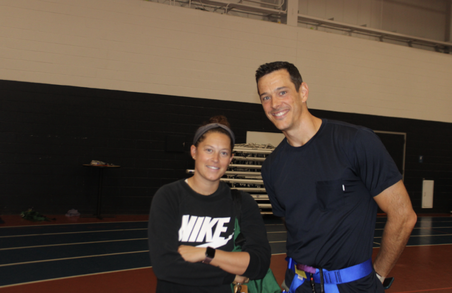 Teachers Nicole Cumerford and Jeffrey Dornweerd administer the Sophomores climbing the ropes course. 
