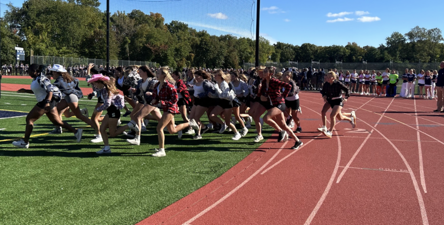 The girls cross country team danced to Cotton Eyed Joe in Western clothes like flannels and cowboy hats.