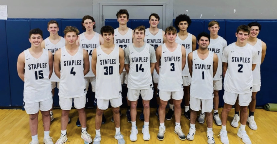 The 2022 boys’ varsity basketball team gathers as a team before their first game.