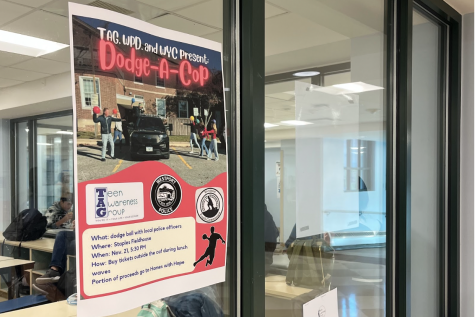 Outside of the cafeteria, there are posters with details about the event as well as a group of students from either the Westport Youth Commission or TAG selling tickets.  