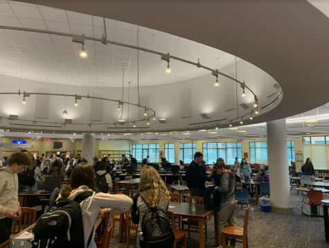The library swarms with students during free time, causing the library to reach loud noises that are disturbing to students.