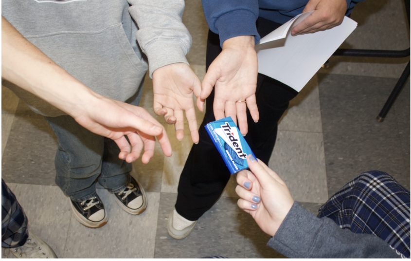 Students jump at the opportunity to steal a piece of gum from a peer. Gum is a highly requested item among peers to share.