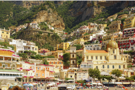 This photo is taken from a ferry going along the Amalfi Coast; this stop is in Positano, Italy. From Easter to October, they have about 12,000 tourists. This seaside paradise has colorful, cliffside villas towering over their black sand beach. 