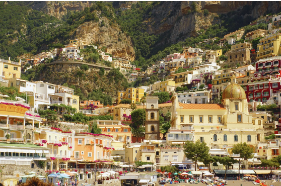 This photo is taken from a ferry going along the Amalfi Coast; this stop is in Positano, Italy. From Easter to October, they have about 12,000 tourists. This seaside paradise has colorful, cliffside villas towering over their black sand beach. 