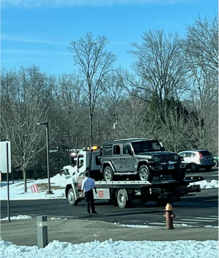 The Jeep that crashed into the school is towed away after students are allowed to reenter the building.