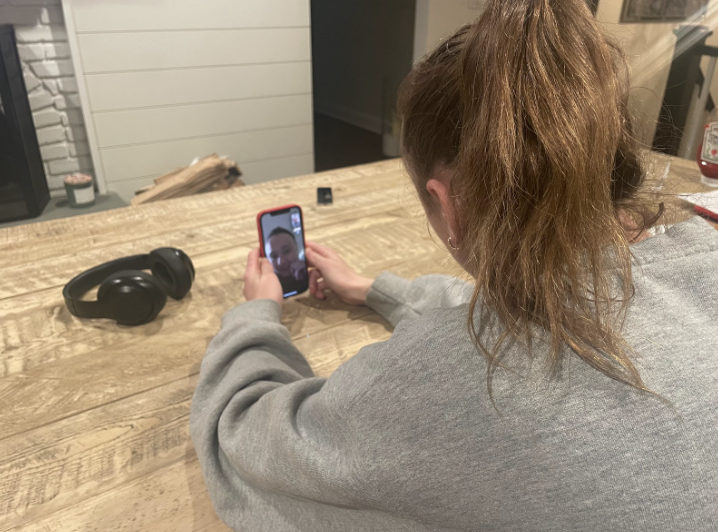 A younger sibling Facetimes her sister who is currently at college. 