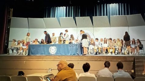 New members of NHS for the class of 2024 sit on stage waiting to be inducted at the ceremony on April 26 at Staples High School.