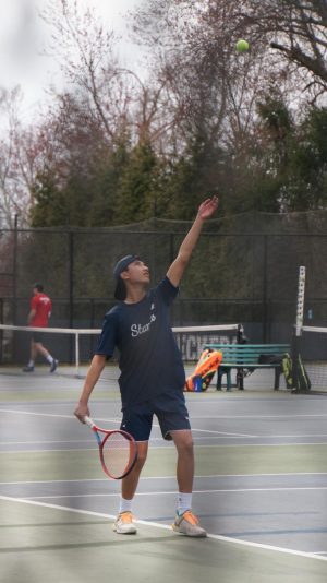 Mattie Guadarrama ’25 prepares to hit the opening serve in his match against New Canaan.
