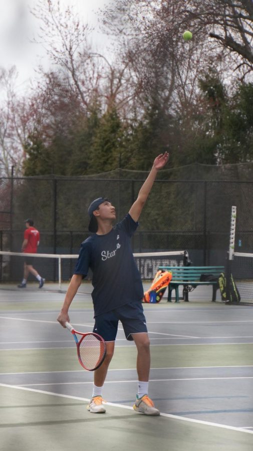 Mattie Guadarrama ’25 prepares to hit the opening serve in his match against New Canaan.
