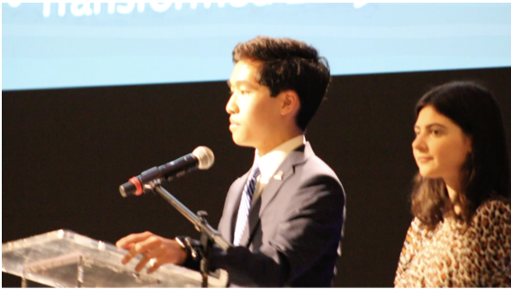 Spencer Yim 23 delivers his speech to the crowd at the Westport Library. Mia Bomback 25, to the right, had previously spoken to the audience. Photo by Benjamin Buchalter 25. 