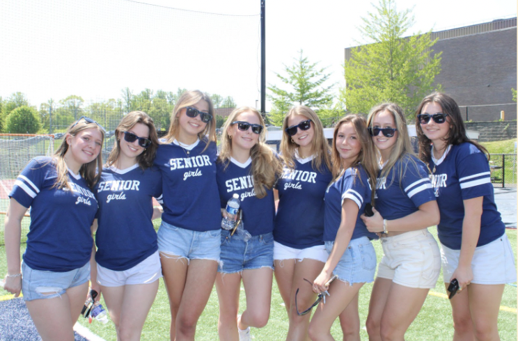 From right to left: Emma Porzio ’23, Grace Fuori ’23, Brooke Devine ’23, Sasha Chamlin ’23,  Emma Mechanic ’23, Genevieve Clark ’23, Jenny Bradshaw ‘’23, Carly Chamlin ’23 celebrate their last day as Staples students, wearing customized Staples sunglasses given to them at the picnic.