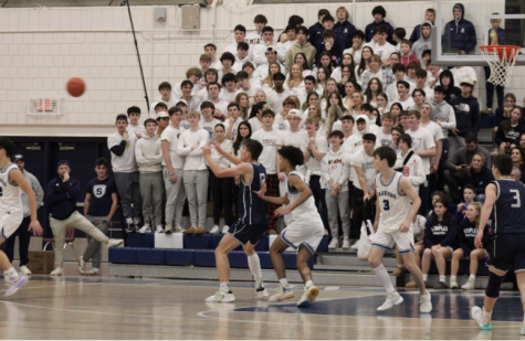 The Staples Superfans lead the student section in cheers as the boys’ basketball team play against the Wilton Warriors. 

